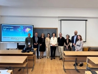 group of people standing in front of a classroom